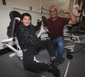 George Guinto, 12, works out on weight machines with his dad Brian at Variety Village on Wednesday, Nov. 22, 2023.