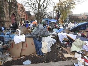 A homeless encampment outside of St. Stephen-In-The-Fields Anglican Church in Kensington Market was partially dismantled by the City of Toronto on Friday, Nov. 24, 2023.