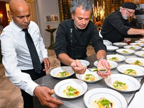 Toronto chef Sash Simpson, centre, prepares a meal as part of a fundraiser for the University Health Network last month.