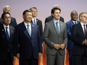 Prime Minister Justin Trudeau stands next to Chinese President Xi Jinping and other leaders for the family photo at the APEC Summit, in San Francisco, Calif., Thursday, Nov. 16, 2023.