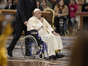 Pope Francis arrives to preside over a mass while in a wheelchair.