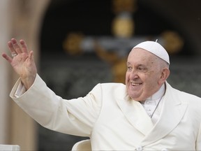 Pope Francis smiles as he waves faithful at the end of his weekly general audience in St. Peter's Square, at the Vatican, Wednesday, Nov. 22, 2023.
