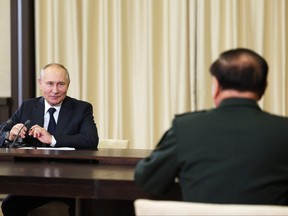 This pool photograph distributed by Russian state owned agency Sputnik shows President Vladimir Putin meeting with Deputy Chairman of the Central Military Commission of the People's Republic of China Zhang Yuxia (right) in Novo-Ogaryovo, outside Moscow, on Nov. 8, 2023.
