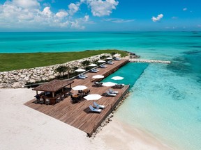 Wymara Resort + Villas' in-ocean pool, deck and tiki bar at Sunset Cove Beach in Turks and Caicos.