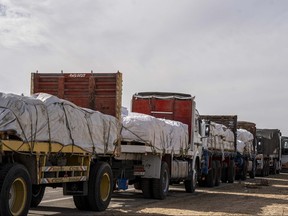 Trucks carrying aid await an opportunity to enter Gaza via the Rafah crossing on Nov. 22, 2023 in Arish, Egypt.