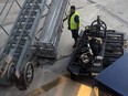 Screengrab of wheelchair getting launched off ramp while baggage handler watches