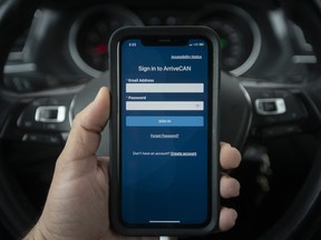 Smartphone showing ArriveCAN app inside a car