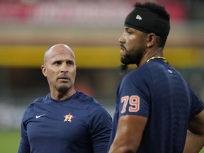 FILE - Houston Astros bench coach Joe Espada talks with first baseman Jose Abreu before Opening Day against the Chicago White Sox, Thursday, March 30, 2023, in Houston. Espada will be introduced as manager of the Houston Astros on Monday, Nov. 13, a person familiar with the hiring told The Associated Press. The person spoke to the AP on condition of anonymity Sunday because the team hadn't announced the decision.