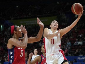 Canada's Natalie Achonwa, right, shoots over United States' A'ja Wilson during their semifinal game at the women's Basketball World Cup in Sydney, Australia, Friday, Sept. 30, 2022.