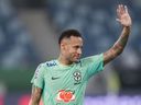 Brazil's Neymar waves to fans during a training session in Cuiaba, Brazil, on Tuesday, Oct. 10, 2023. Thieves entered the home of Neymar's partner and took her parents hostage Tuesday morning, she says on Instagram.