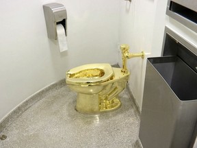 This Sept. 16, 2016 file image made from a video shows the 18-karat toilet, titled "America," by Maurizio Cattelan in the restroom of the Solomon R. Guggenheim Museum in New York