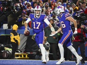 Buffalo Bills quarterback Josh Allen, left, celebrates after his touchdown with Dalton Kincaid during the second half of an NFL football game against the Denver Broncos, Monday, Nov. 13, 2023, in Orchard Park, N.Y.