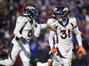 Denver Broncos' Justin Simmons (31) reacts after intercepting a pass thrown by Buffalo Bills quarterback Josh Allen during the first half of an NFL football game, Monday, Nov. 13, 2023, in Orchard Park, N.Y.