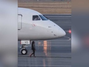 A woman is pictured on the tarmac at Canberra Airport before a plane was scheduled to take off.