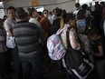 Palestinians and foreign aid workers wait to cross into Egypt