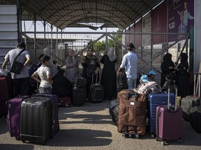 Palestinians wait to cross into Egypt at Rafah