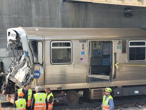 This handout photo provided by the Chicago Fire Department on Nov. 16, 2023, shows workers examining the damage to a CTA train in Chicago, Ill.