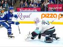 Toronto Maple Leafs' Mitchell Marner scores against Seattle Kraken goaltender Philipp Grubauer during second period NHL hockey action in Toronto on Thursday, Nov. 30, 2023.