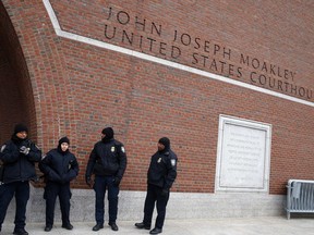 FILE - Police stand guard outside the federal courthouse in Boston, Tuesday, Jan. 6, 2015. Three people have been arrested on allegations that they ran a sophisticated commercial sex ring in Massachusetts and Virginia that catered to well-connected clients such as elected officials and military officers, federal prosecutors said on Wednesday., Nov. 8, 2023.