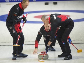 Team Canada skip Brad Gushue makes a shot as lead Geoff Walker, left, and second E.J. Harnden sweep as they take on Taiwan at the Pan Continental Curling Championship in Kelowna, B.C. in this Wednesday, Nov. 1, 2023 handout photo.
