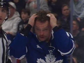 Maple Leafs forward Max Domi pulls his hair while staring down Florida Panthers' Sam Bennette, who is bald, following their fight on Monday night in Toronto.