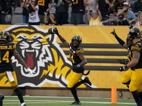 Hamilton Tiger-Cats defensive back Chris Edwards (24) celebrates an interception during first half CFL football game action against the Ottawa Redblacks in Hamilton, Ont. on Saturday, July 8, 2023.&ampnbsp;Hamilton Tiger-Cats defensive back Chris Edwards, no stranger to CFL discipline, has been suspended three games for instigating a fight in the dying seconds of Saturday's CFL Eastern semifinal in Montreal.