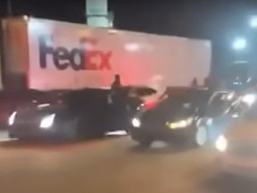 Screengrab of FedEx truck boxed in by cars