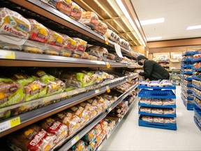 A worker restocks shelves in the bakery and bread aisle at an Atlantic Superstore grocery in Halifax, Friday, Jan. 28, 2022. Nova Scotia's community food coupon program costs approximately $350,000