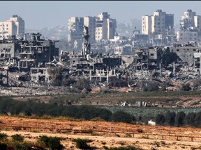 This picture taken from a position along the border with the Gaza Strip in southern Israel on Nov. 8, 2023 shows a view of buildings destroyed in the north of the Palestinian enclave following Israeli bombardment amid the ongoing battles between Israel and the Palestinian group Hamas.