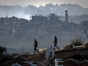 Men walk on Nov. 13, 2023 along the border with the Gaza Strip in southern Israel amid ongoing battles between Israel and the Palestinian militant group Hamas.