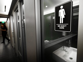 In this May 10, 2016 file photo, gender neutral signs are posted in a washroom in Durham, N.C.