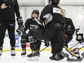 Forward Sarah Nurse listens while Troy Ryan, head coach speaks to players during the Professional Women's Hockey League's training camp in Toronto, Friday, Nov., 17, 2023.