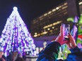 Person taking photo of Christmas tree.