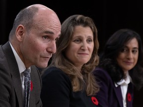 Deputy Prime Minister and Minister of Finance Chrystia Freeland and President of the Treasury Board Anita Anand look on as Public Services and Procurement Minister Jean-Yves Duclos speaks during a news conference, Tuesday, November 7, 2023 in Ottawa.