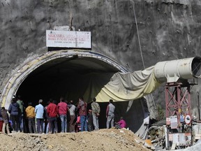 People watch rescue and relief operations at the site of an under-construction road tunnel that collapsed in mountainous Uttarakhand state, India, Wednesday, Nov. 15, 2023.