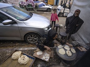 Palestinians displaced by the Israeli bombardment of the Gaza Strip prepare bread in a UNDP-provided tent camp in Khan Younis, Wednesday, Nov.15, 2023.