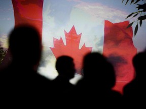 The Canadian flag on a screen as the national anthem plays at the Prospectors & Developers Association of Canada conference in Toronto, March 5, 2023.
