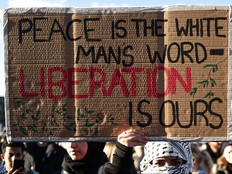 A protester holds a placard while taking part in the National March For Palestine in central London on Nov. 11, 2023, calling for a ceasefire in the conflict between Israel and Hamas.