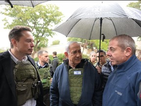 In this handout image provided by the GPO, Israel's Prime Minister Benjamin Netanyahu (centre) takes Elon Musk (left) on a tour of Kibbutz Kfar Aza after the October 7th Massacre took place there, on Nov. 27, 2023 in Kfar Aza, Israel.