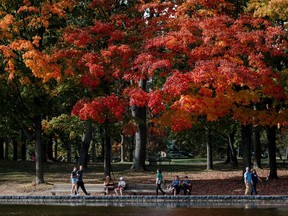 People walk near the Lac-aux-Castors at Mont-Royal in Montreal on Oct. 5, 2023.