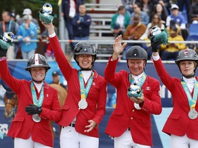 Canada celebrates their silver medal in equestrian jumping at the Santiago 2023 Pan American Games in Quillota, Chile, Wednesday, Nov. 1, 2023. From left to right: Beth Underhill, Amy Millar, Mario Deslauriers, and Tiffany Foster.