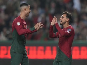 Portugal's Ricardo Horta, right, celebrates with Portugal's Cristiano Ronaldo after scoring his side's second goal during the Euro 2024 group J qualifying soccer match between Portugal and Iceland, at the Alvalade Stadium in Lisbon, Sunday, Nov. 19, 2023.