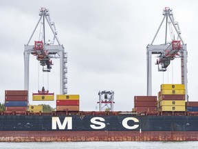 A shipping container is loaded onto a container ship in the Port of Montreal, Tuesday, Sept.19, 2023.
