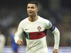 FILE - Portugal's Cristiano Ronaldo reacts after scoring during the Euro 2024 group J qualifying soccer match against Bosnia-Herzegovina at the Bilino Polje Stadium in Zenica, Bosnia and Herzegovina, Oct. 16, 2023. Ronaldo has been hit with a billion dollar class-action lawsuit over his role in promoting cryptocurrency-related "non-fungible tokens," or NFTs, issued by the beleaguered cryptocurrency exchange Binance. The lawsuit, filed in federal court in the Southern District of Florida Monday, Nov. 27, 2023 accuses Ronaldo's promotions of Binance of being "deceptive and unlawful."