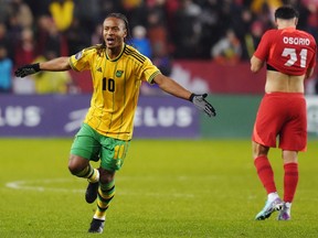 Jamaica's Bobby Reid (10) celebrates after defeating Canada as Jonathan Osorio (21) reacts following CONCACAF Nations League quarterfinal soccer action in Toronto on Tuesday, November 21, 2023.
