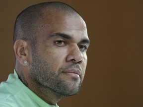 FILE - Brazil's Dani Alves listens to a question during a press conference on the eve of the group G of World Cup soccer match between Brazil and Cameroon in Doha, Qatar, on Dec. 1, 2022. Alves will face trial for allegedly having sexually assaulted a woman in a night club last year, a Spanish judge ordered Tuesday Nov. 14, 2023.