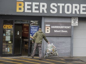 A customer returns beer cans to a beer store in Toronto.