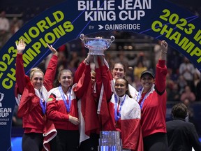 Canada's Leylah Fernandez, right, lifts the trophy with members of her team after wining the final singles tennis match against Italy's Jasmine Paolini, during the Billie Jean King Cup finals in La Cartuja stadium in Seville, southern Spain, Spain, Sunday, Nov. 12, 2023.