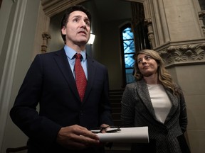 Minister of Foreign Affairs Melanie Joly looks on as Prime Minister Justin Trudeau speaks to reporters before caucus, Wednesday, Nov. 22, 2023 in Ottawa.
