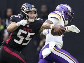Minnesota Vikings quarterback Joshua Dobbs, right, runs for a touchdown past Atlanta Falcons linebacker Kaden Elliss (55) during the second half of an NFL football game, Sunday, Nov. 5, 2023, in Atlanta.